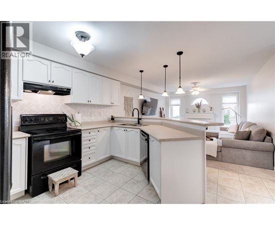 A kitchen with white cabinets and a black stove top oven.