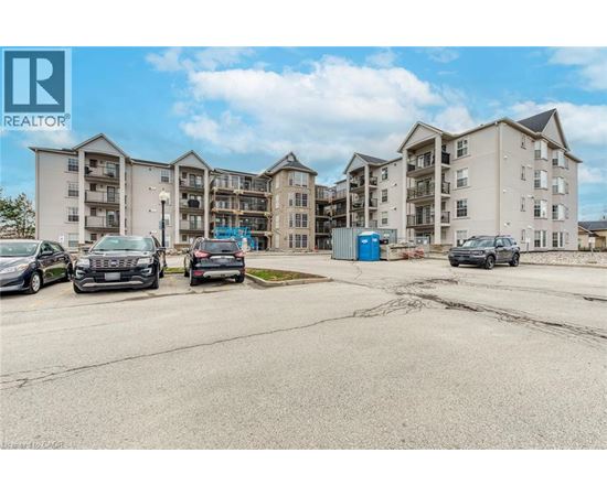 A parking lot with cars and apartment buildings in the background.