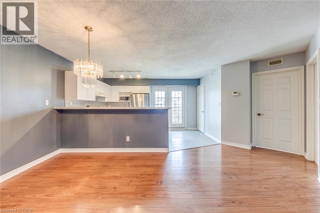 A spacious living room with hardwood floors and a large window.
