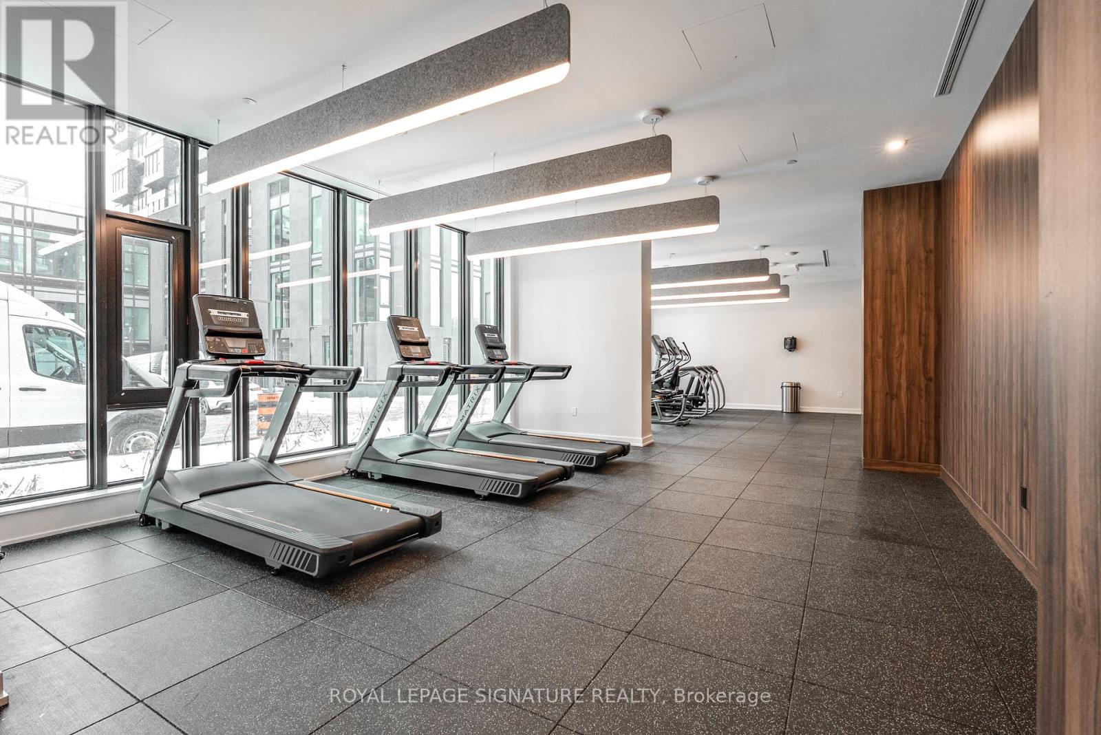 A gym with treadmills and a bicycle in a modern building.