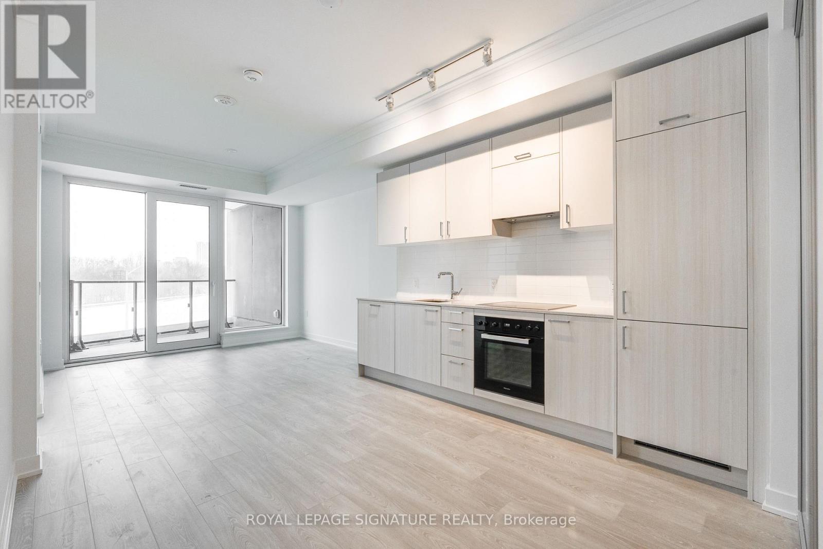 A spacious kitchen with white cabinets and a large island.