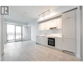 A spacious kitchen with white cabinets and a large island.