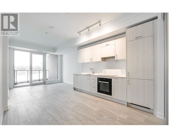 A spacious kitchen with white cabinets and a large island.