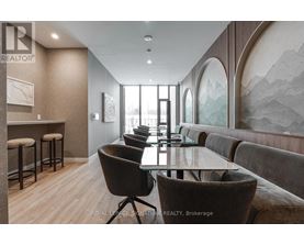 A modern dining room with a glass table and chairs.
