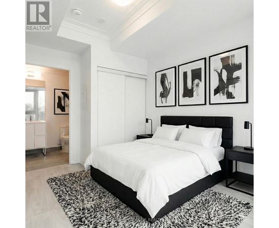 A bedroom with a large bed and three abstract paintings on the wall.