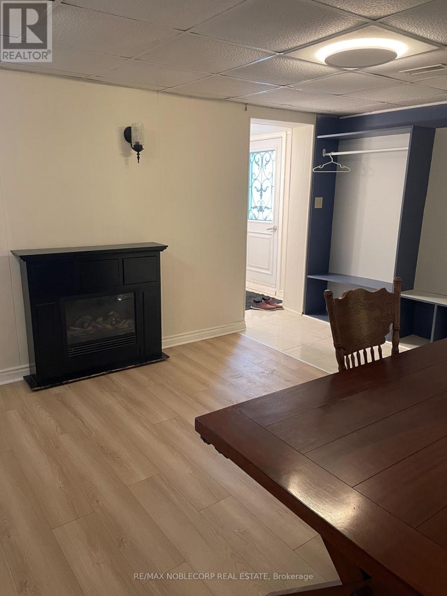 A room with a fireplace and a wooden table.