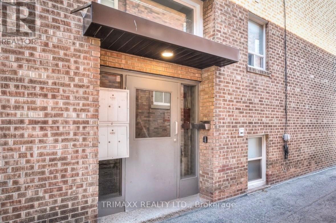 A brick building with a door and windows.