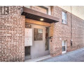 A brick building with a door and windows.