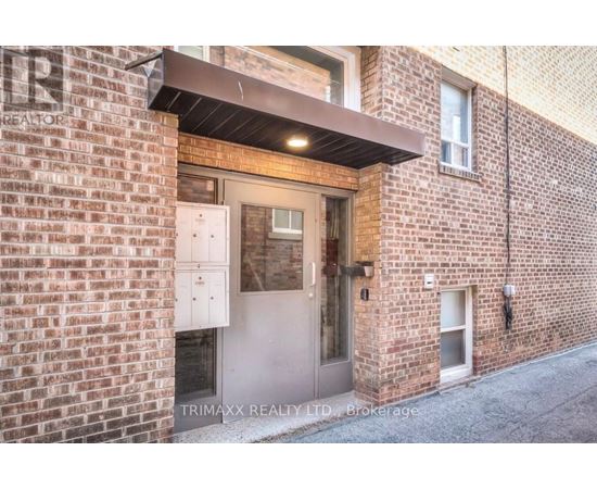 A brick building with a door and windows.