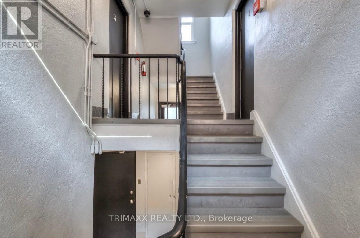 A staircase with a metal railing and wooden steps.