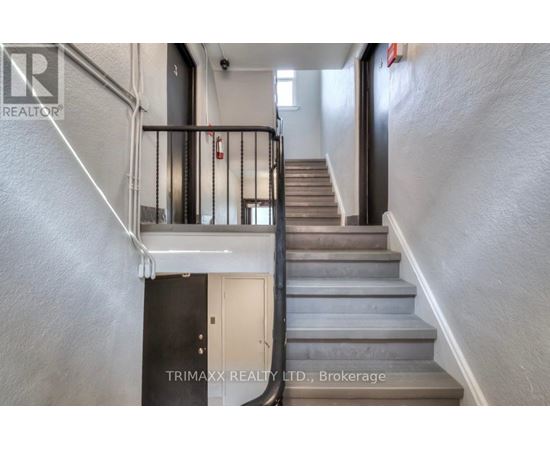 A staircase with a metal railing and wooden steps.