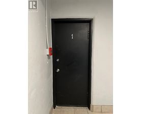 A black door with the number 1 on it.