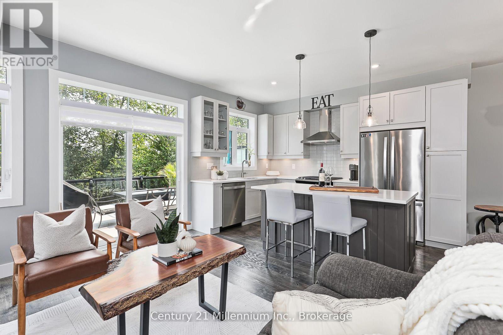A modern kitchen with a dining table and chairs.