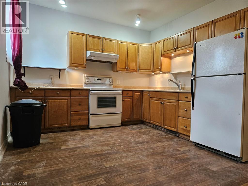 A kitchen with wooden cabinets and a white refrigerator.