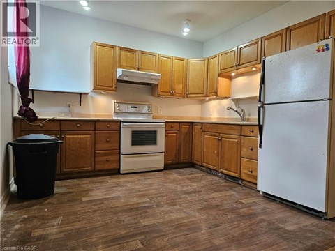 A kitchen with wooden cabinets and a white refrigerator.