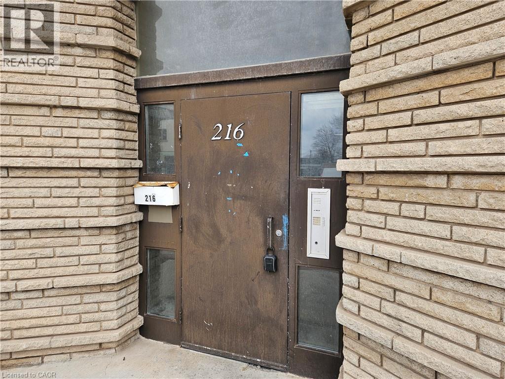 A brown door with the number 216 on it.