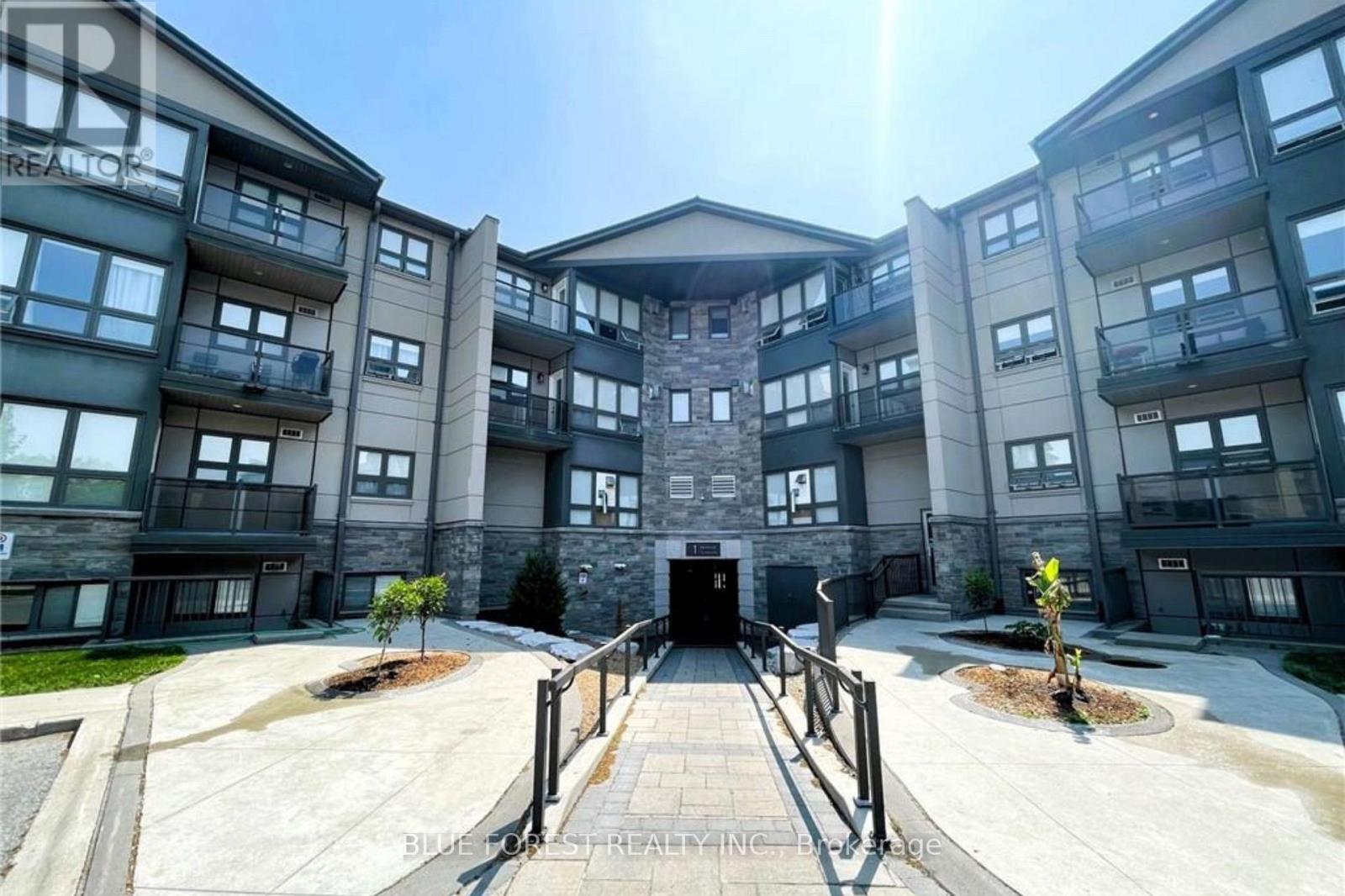 A sunny day at a modern apartment complex with a central courtyard.