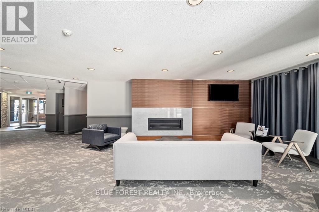 A modern living room with a grey sofa and a wooden accent wall.