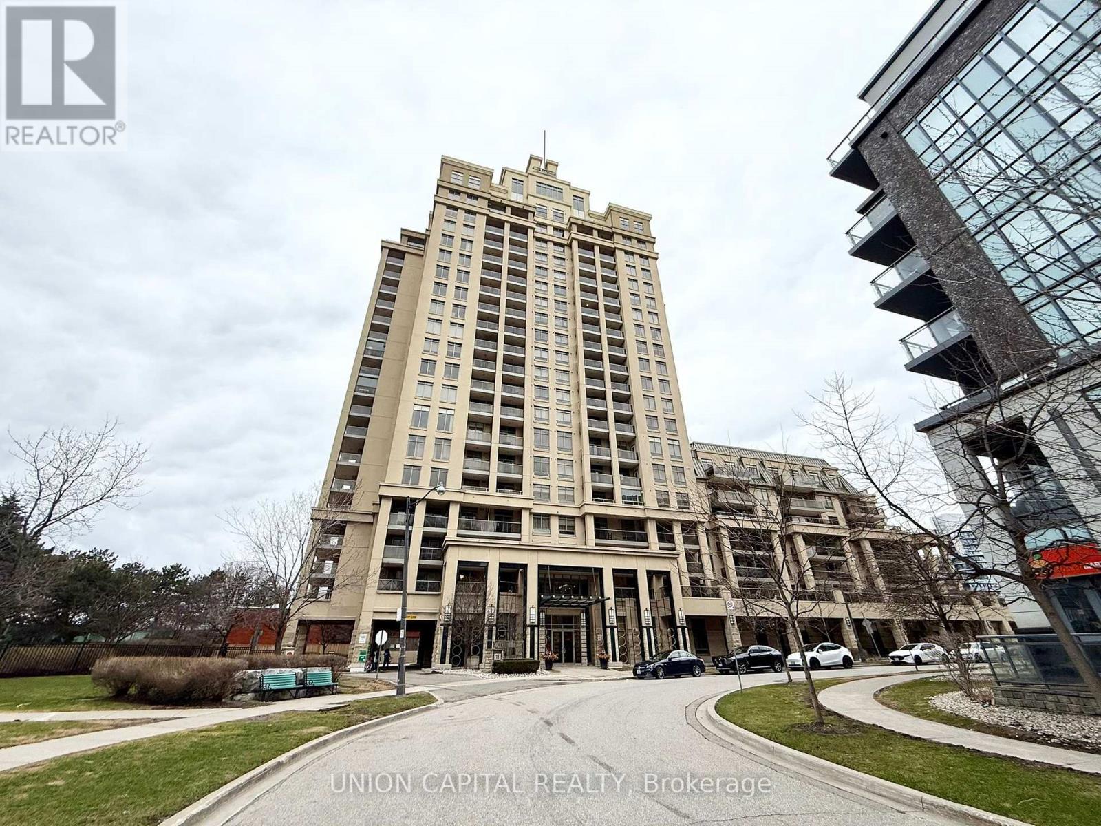 A large building with a lot of windows is in the foreground.