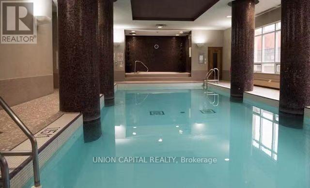 A swimming pool inside a building with a sign that says "REALTOR".