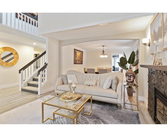 A living room with a white couch and a coffee table.