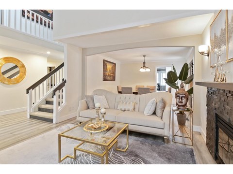 A living room with a white couch and a coffee table.