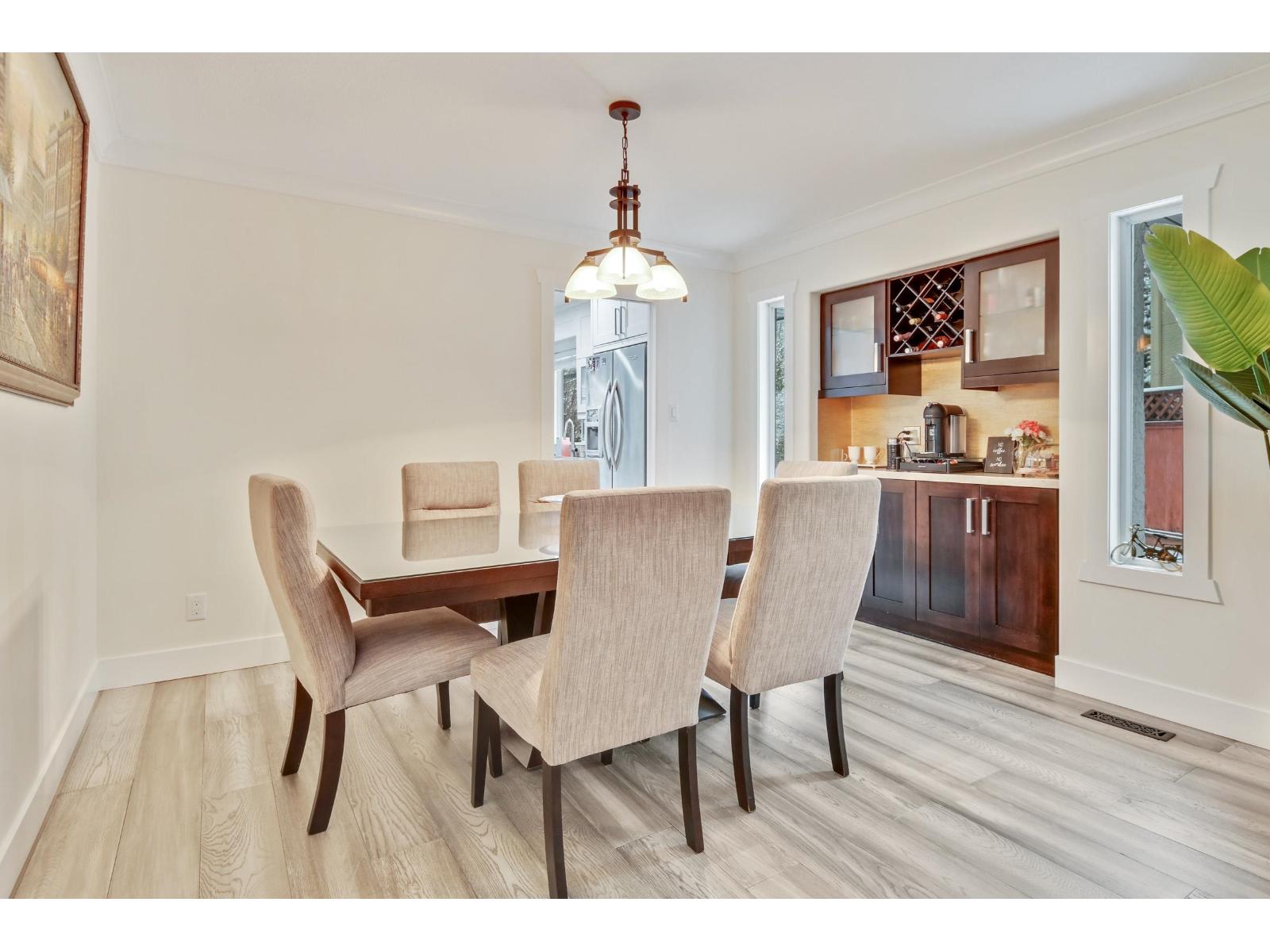 A dining room with a table and chairs.