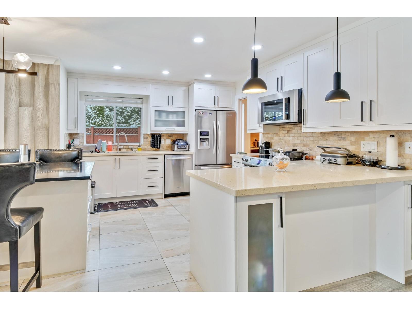 A modern kitchen with white cabinets and a large island.
