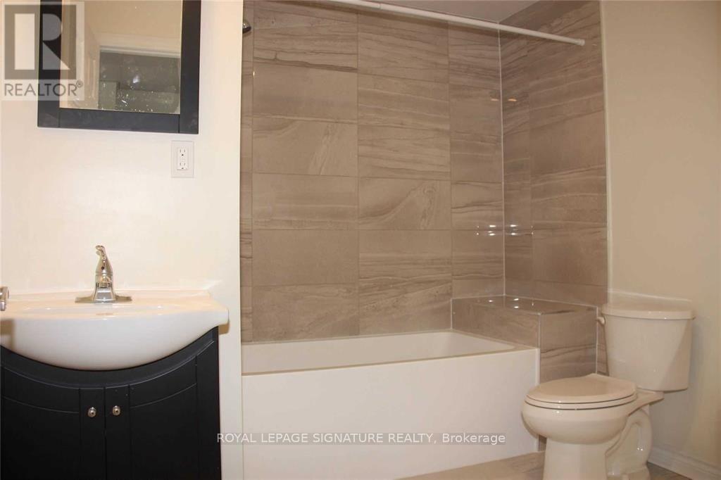 A bathroom with a sink, toilet and bathtub.