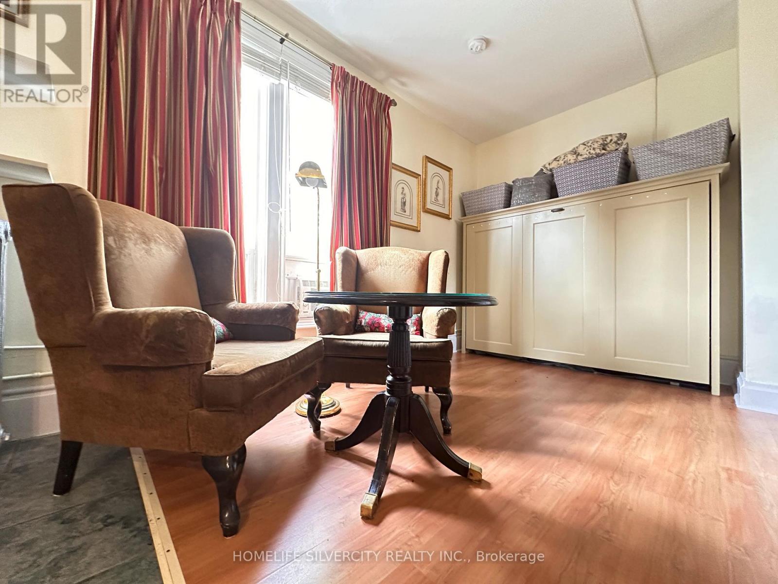 A living room with a brown chair and a brown table.