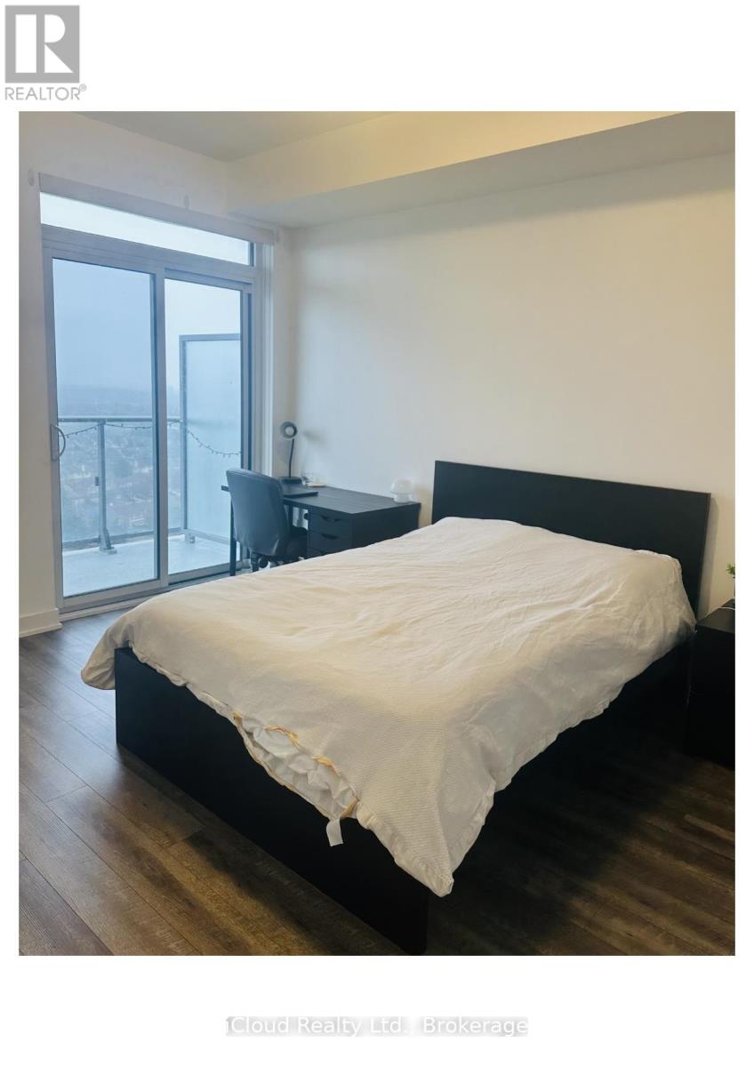 A bedroom with a large bed and a balcony.