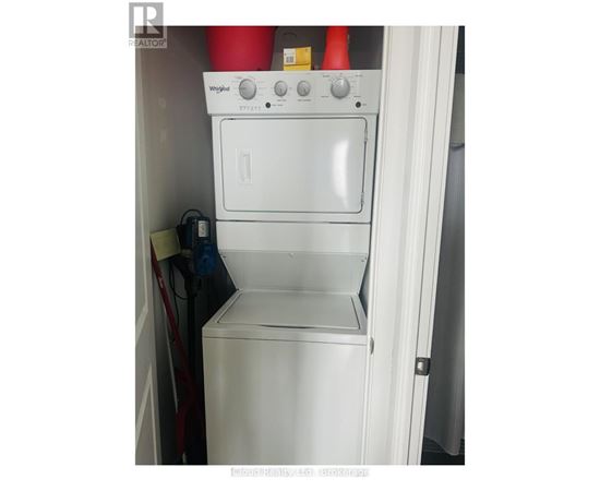 A white Whirlpool oven and dishwasher combo in a small kitchen.