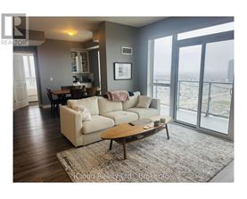 A living room with a couch, coffee table, and sliding glass doors.