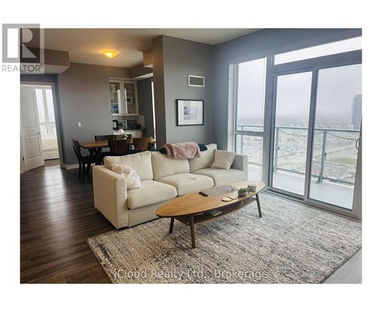 A living room with a couch, coffee table, and sliding glass doors.