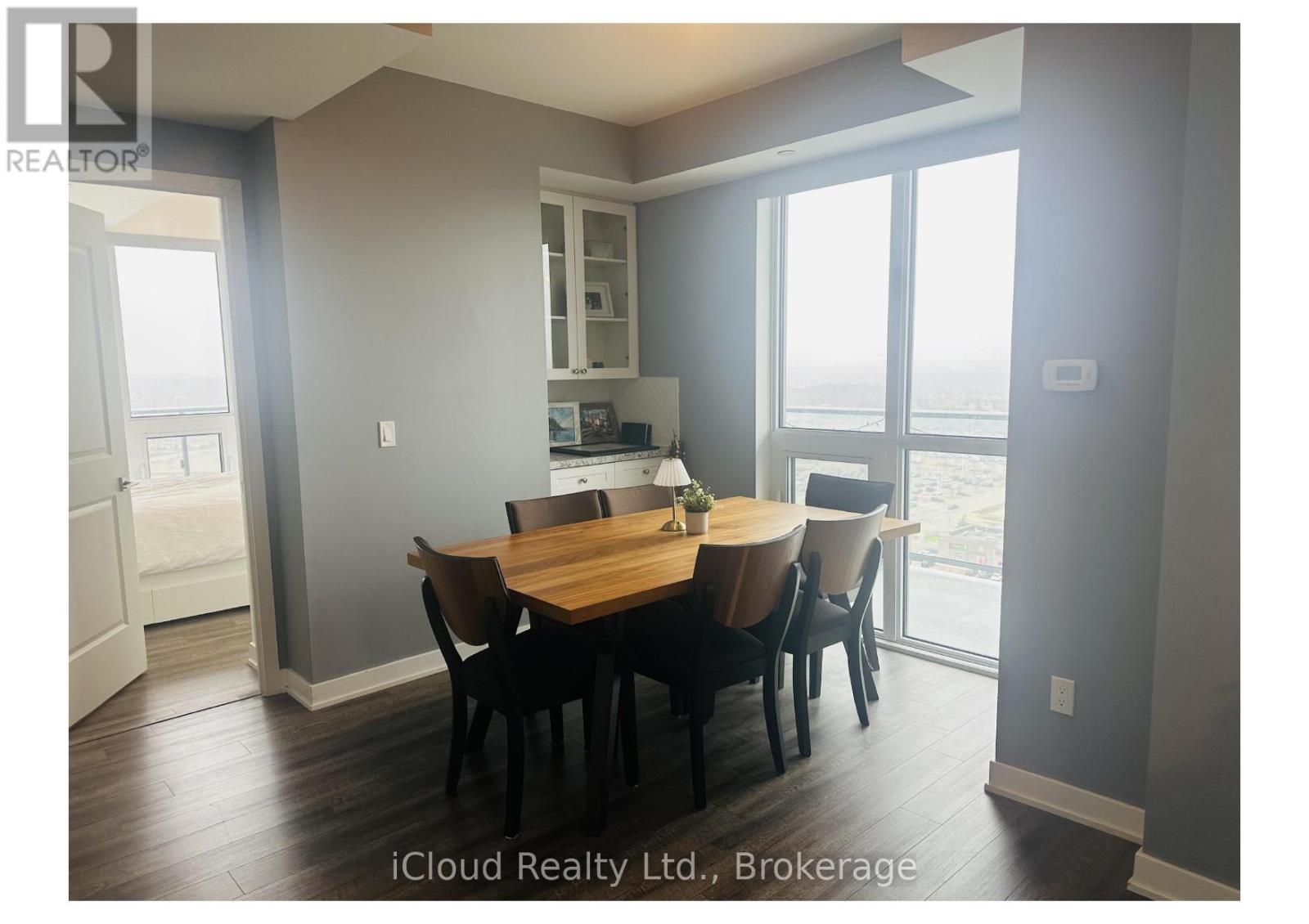 A dining room with a table set for four.