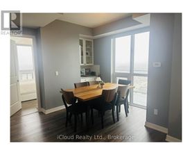 A dining room with a table set for four.