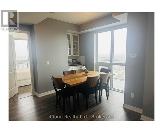 A dining room with a table set for four.