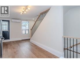A spacious room with a staircase leading to the upper floor.
