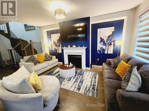 A living room with a fireplace and a television on the wall.