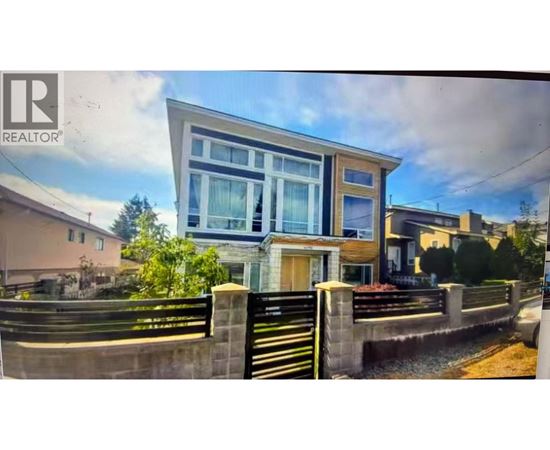 A modern house with a large front yard is for sale.
