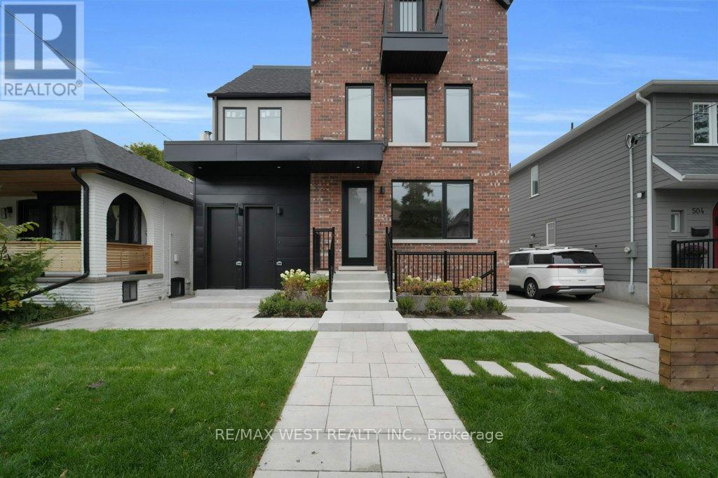 A modern house with a brick chimney and a large front yard.