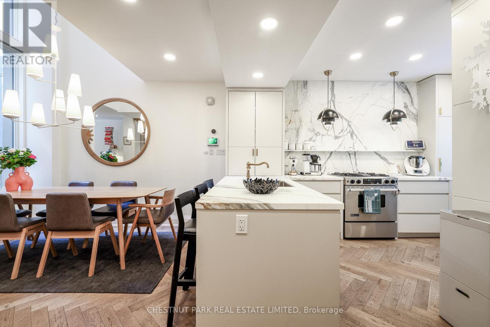 A modern kitchen with a dining table and chairs.