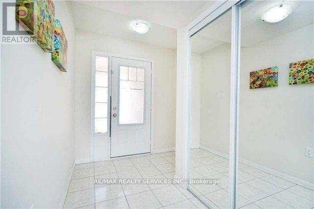 A white door with a glass window is in a room with white walls.