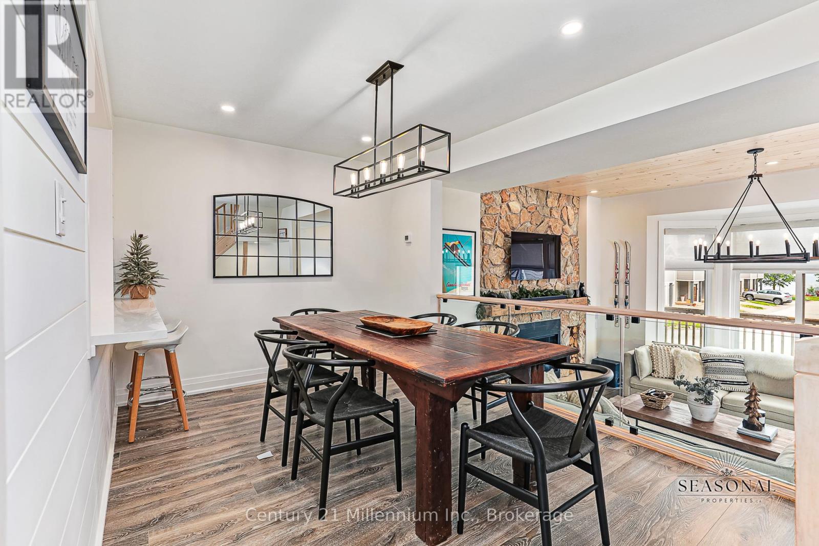A dining room with a wooden table and chairs.