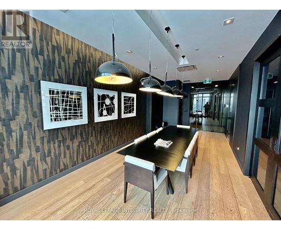 A modern dining room with a wooden table and chairs.