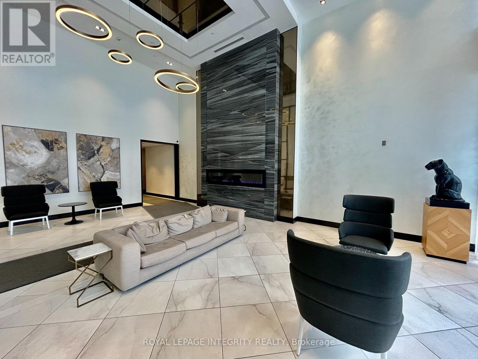 A living room with a grey sofa and a black chair.