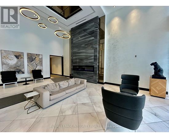 A living room with a grey sofa and a black chair.