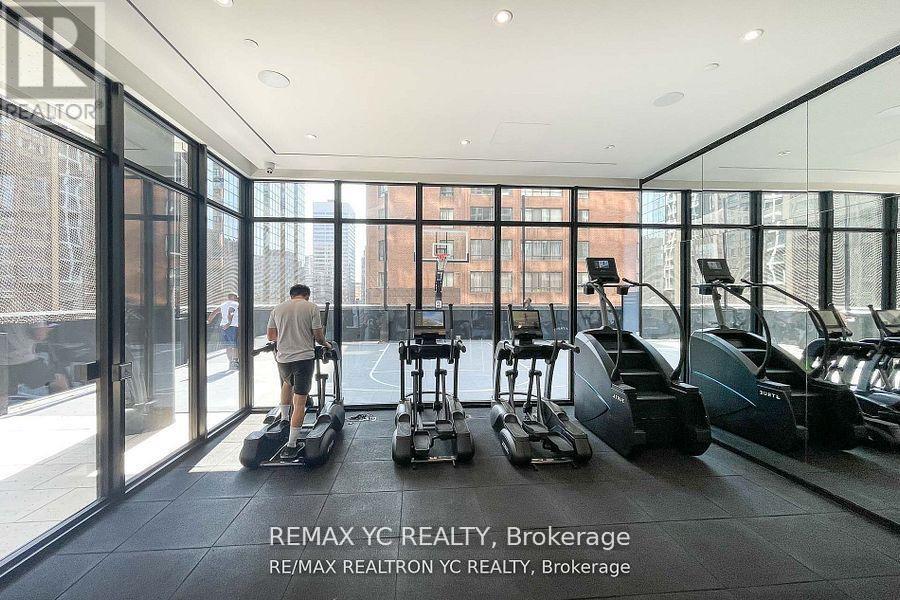 A man is riding a Segway in a spacious room with large windows.