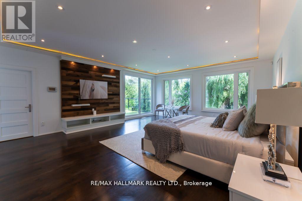 A bedroom with a large bed and a wooden accent wall.