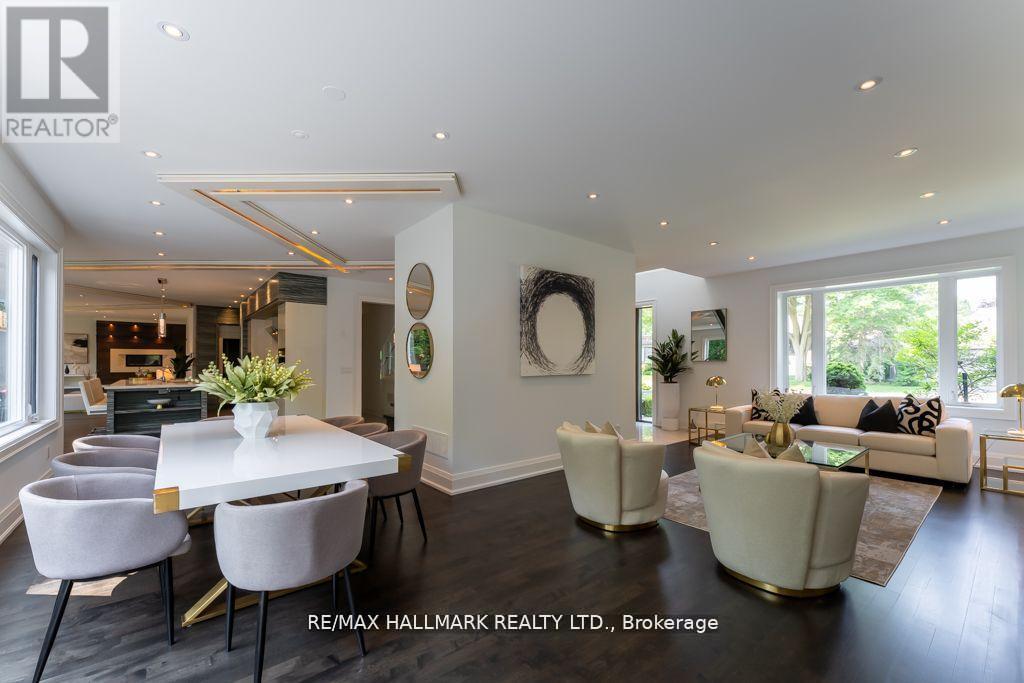 A well-lit, spacious living room with a dining table and chairs.